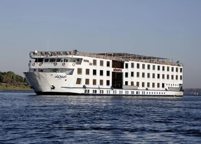 The Movenpick Royal Lily Nile cruise ship on the Nile seen from the bow quarter, its name across the upper deck