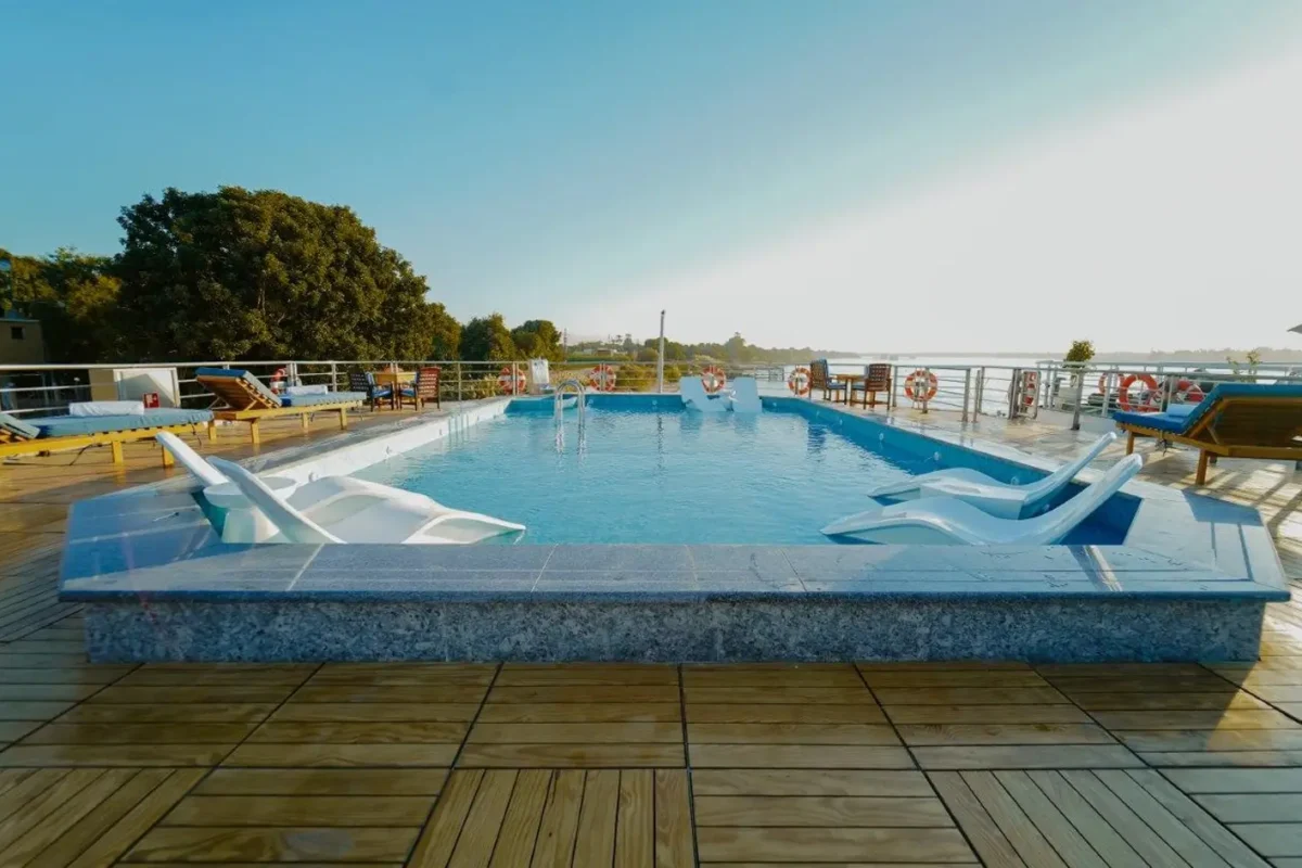The swimming pool on the MS Miriam Nile cruise sun deck, set into a timber deck with loungers along the rail