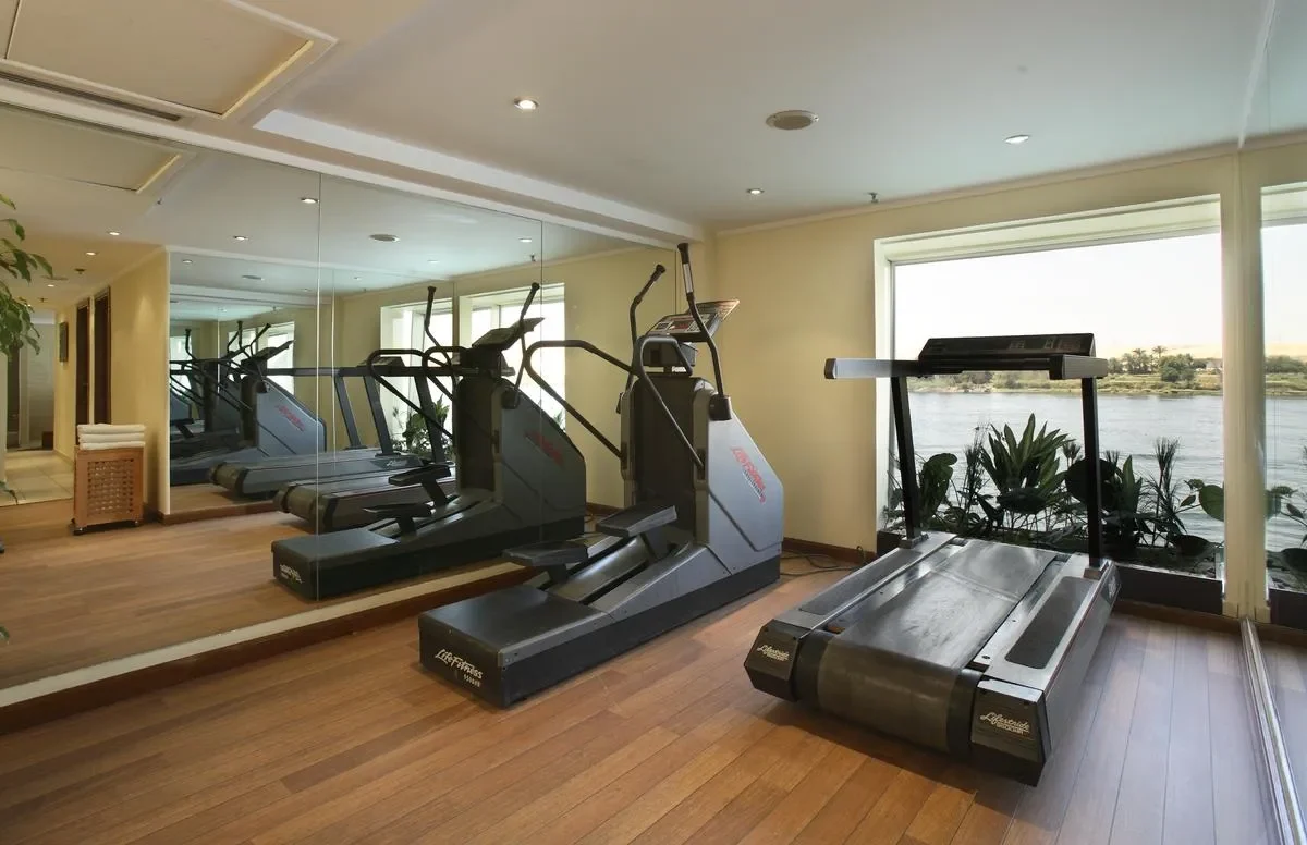 The gym on the Sonesta Star Goddess Nile cruise, treadmills and a cross trainer facing windows onto the Nile