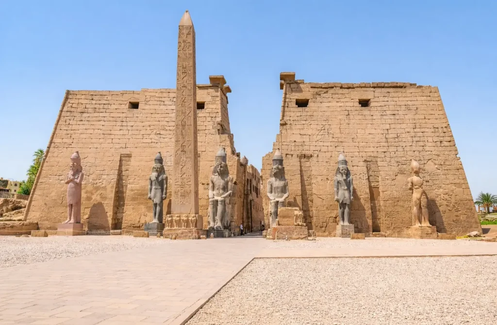 The first pylon of Luxor Temple with its standing obelisk and the seated colossi of Ramses II in front