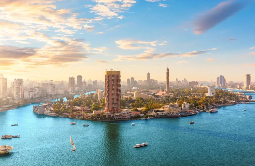 Cairo from above, the Nile curving around Zamalek with the Cairo Tower rising among the buildings