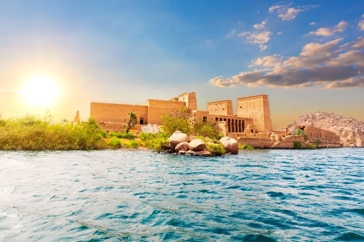 The Temple of Philae on Agilkia Island at sunset, the water of Lake Nasser bright in the foreground