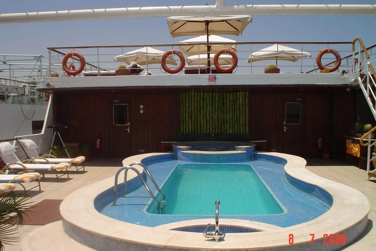 The curved swimming pool on the MS Alexander the Great Nile cruise sun deck, loungers and life rings around it