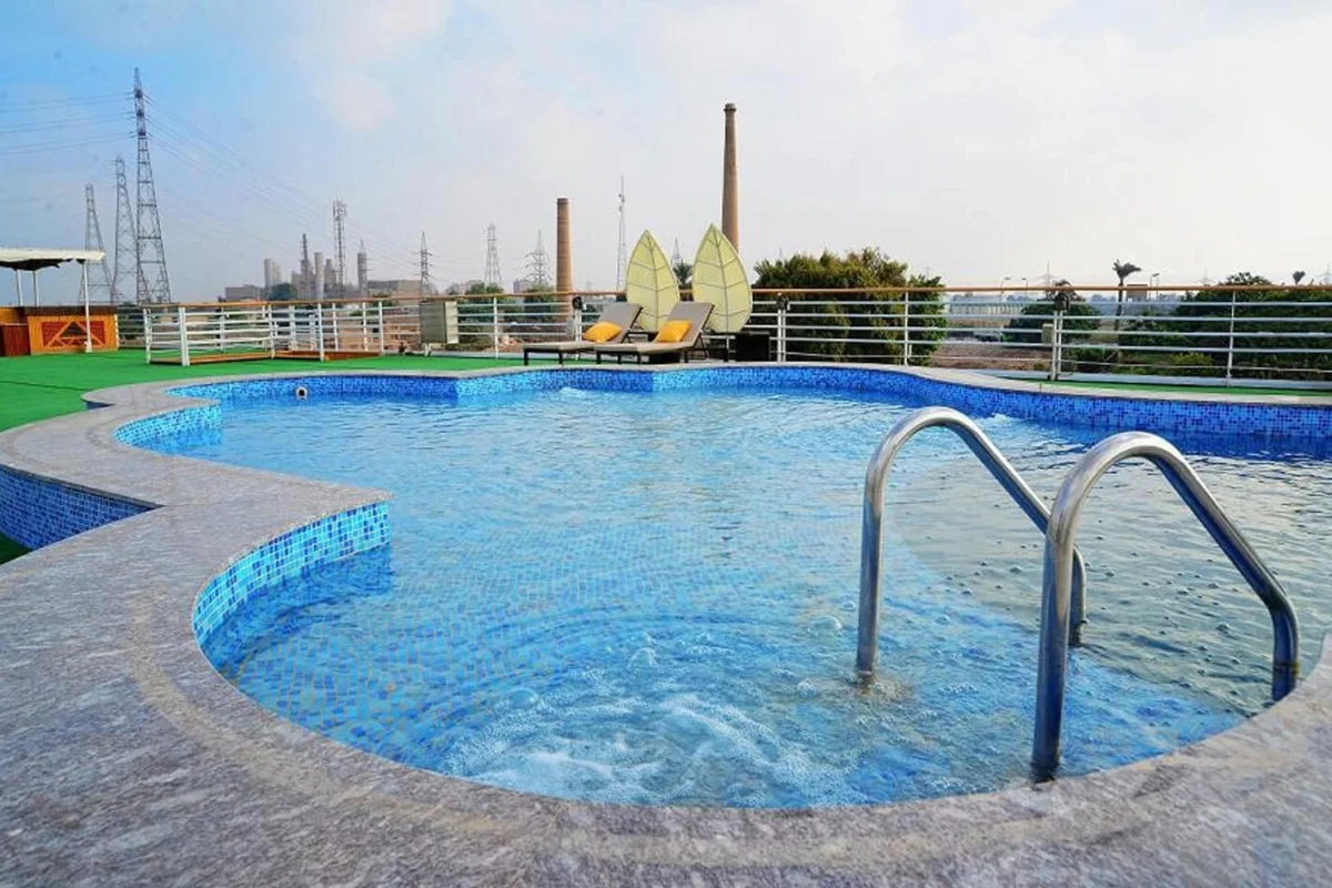 The swimming pool on the Blue Shadow Nile cruise sun deck, with a shallow ledge and handrail steps into the water