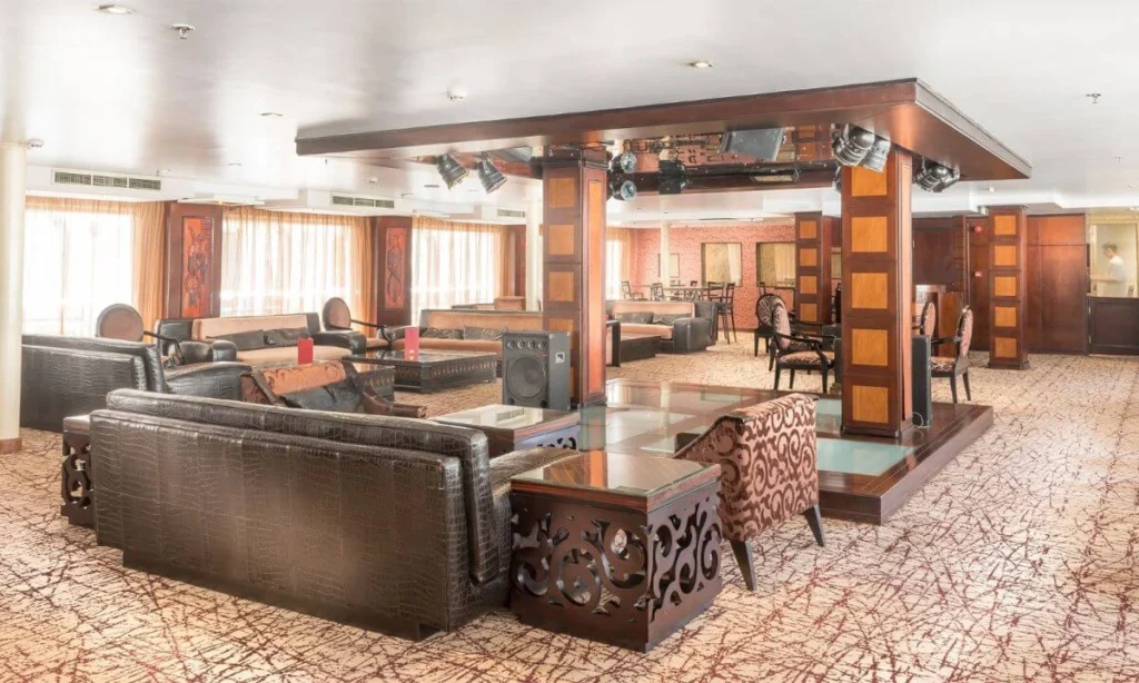 The lounge on the Concerto Nile cruise, leather sofas and carved tables around a central timber column