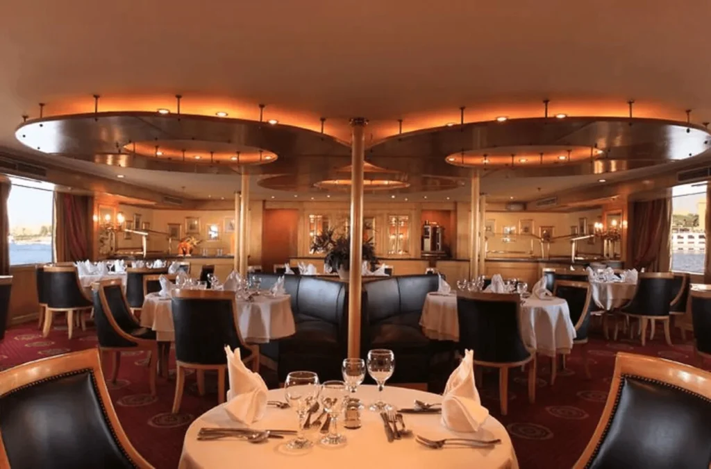 The Iberotel Amara Nile cruise restaurant seen from the entrance, tables set beneath a lit circular ceiling