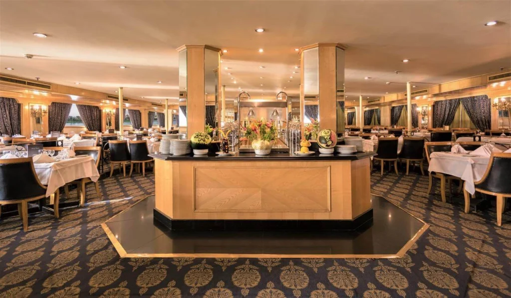 The restaurant on the Jaz Crown Jewel Nile cruise, tables laid around a central buffet island on a patterned carpet