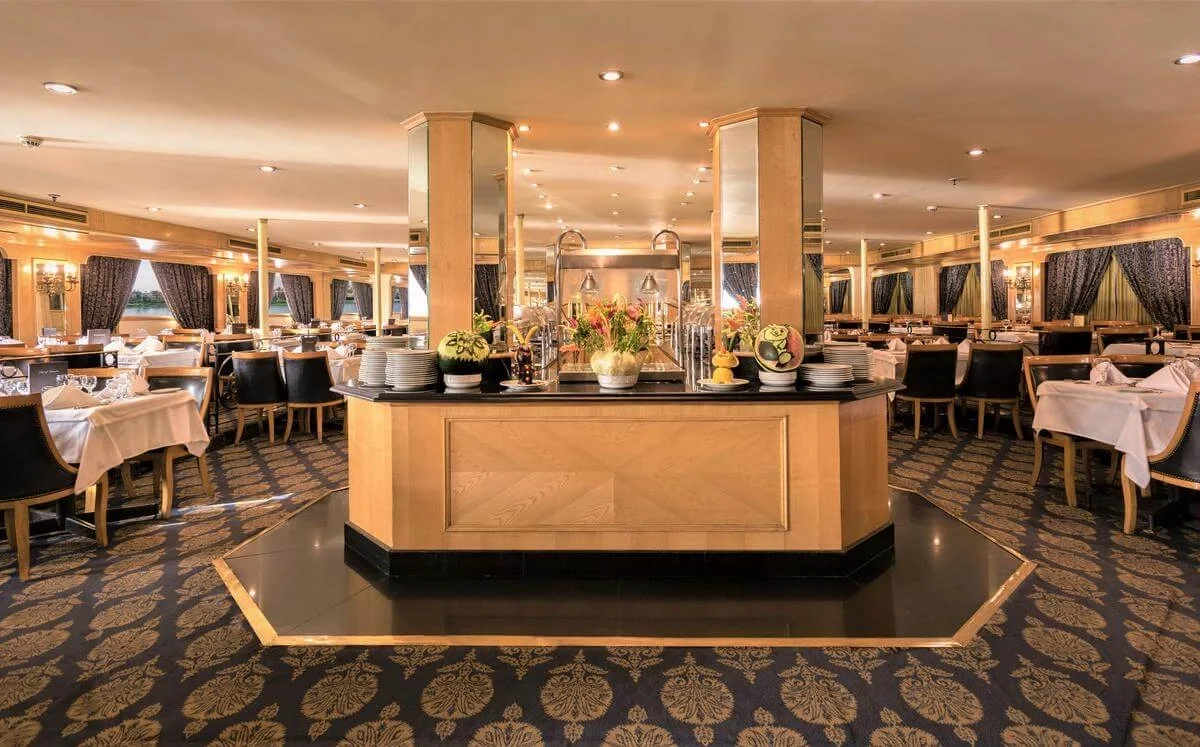 The restaurant on the Jaz Crown Jewel Nile cruise, tables laid around a central buffet island on a patterned carpet