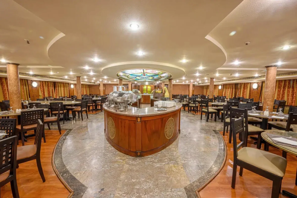 The restaurant on the Magic I Nile cruise, tables around a central buffet island beneath a stained-glass dome
