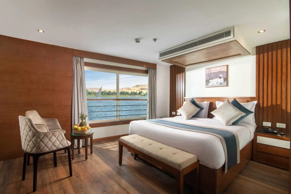 A cabin on the Nile Capital Nile cruise, the bed facing two windows that look straight onto the Nile