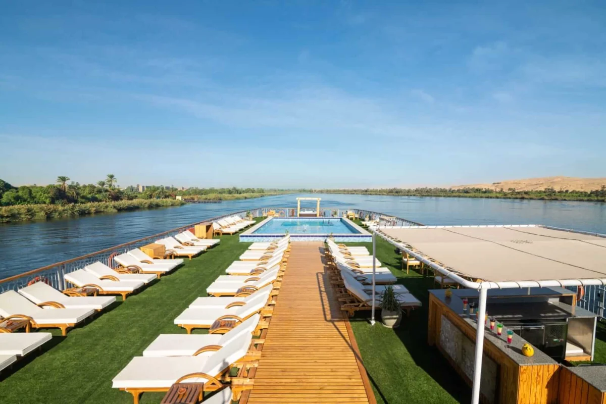 The sun deck of the Nile Capital Nile cruise, loungers along a timber walkway leading to the swimming pool