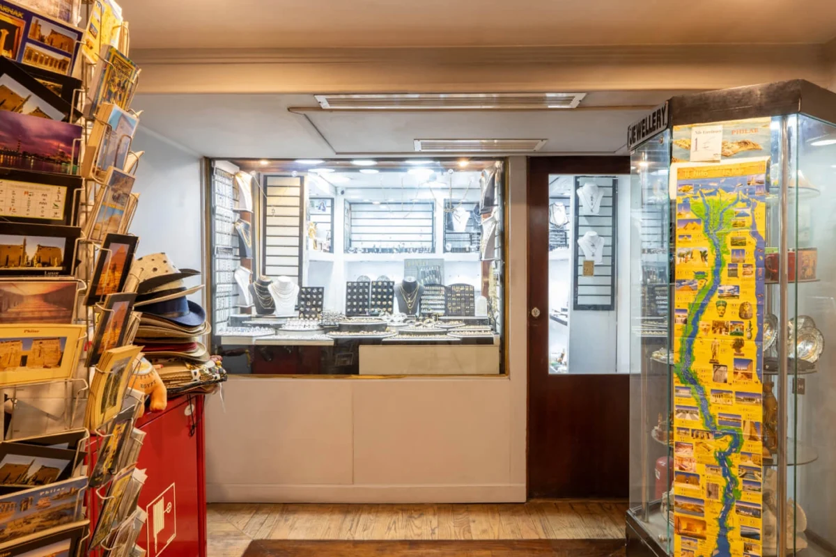 The on-board gift shop of the Nile Excellence Nile cruise, postcards on a rack and jewellery in a glass display case