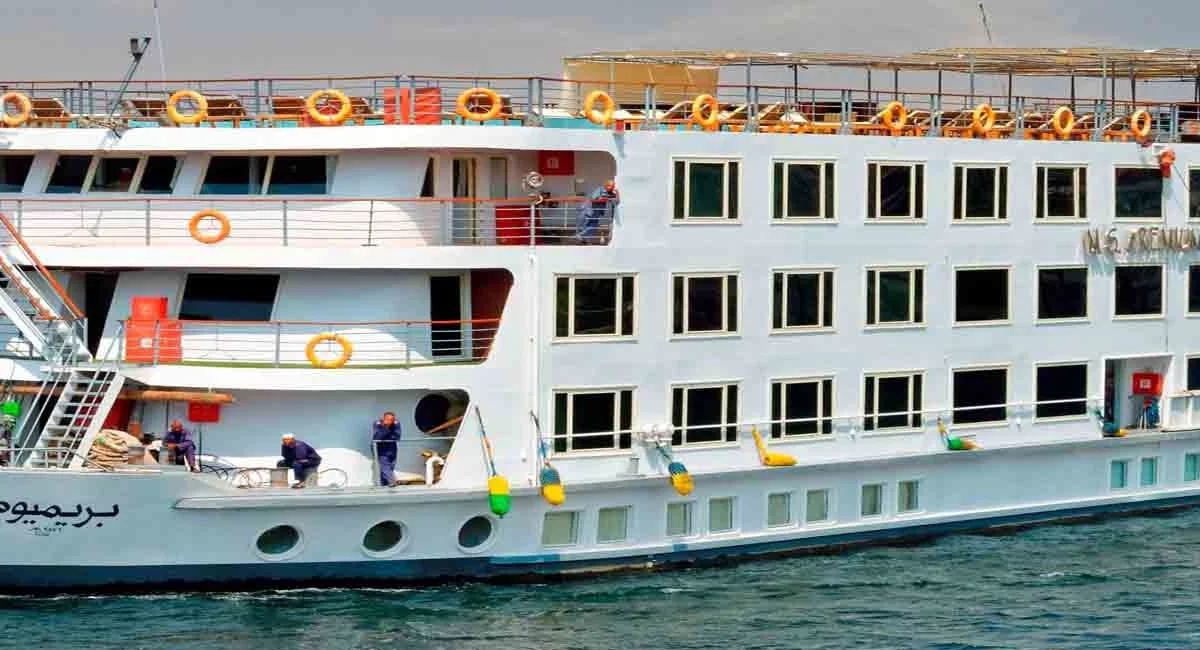 The Nile Premium Nile cruise ship on the Nile, life rings along the rail and its name in Arabic on the bow