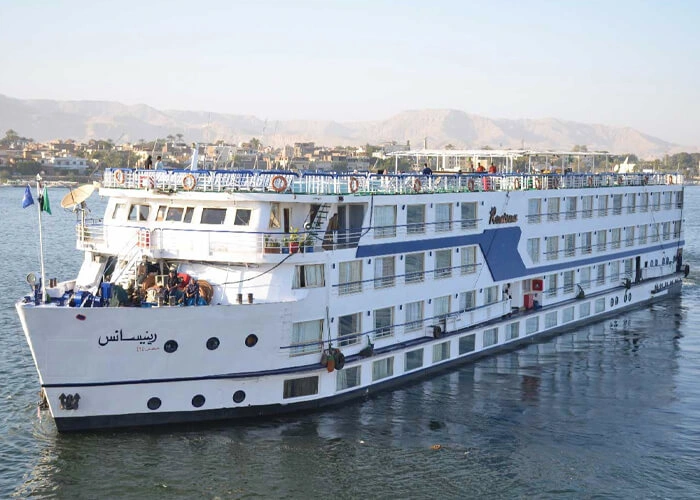 The Renaissance Nile cruise ship on the Nile seen from the bow quarter, hills faint in the haze behind