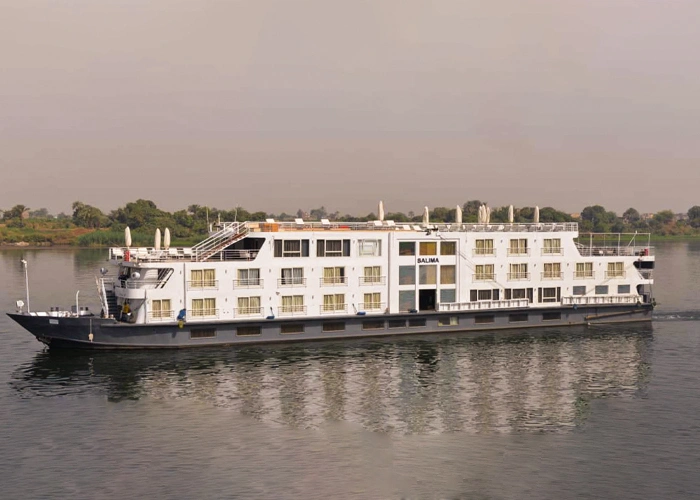 The Salima Nile cruise ship on the Nile in soft haze, its dark hull below three rows of cabin windows