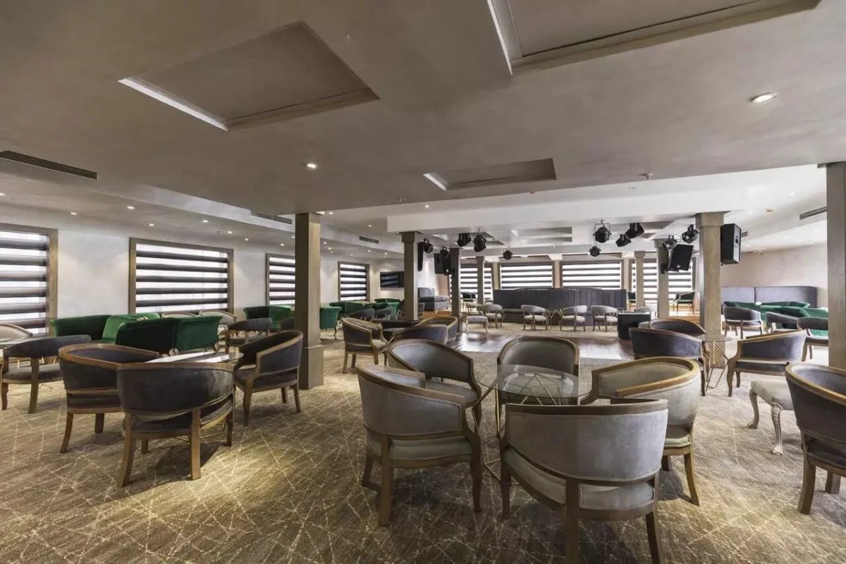 The lounge on the Semramis II Nile cruise, tub chairs around low tables beneath slatted blinds