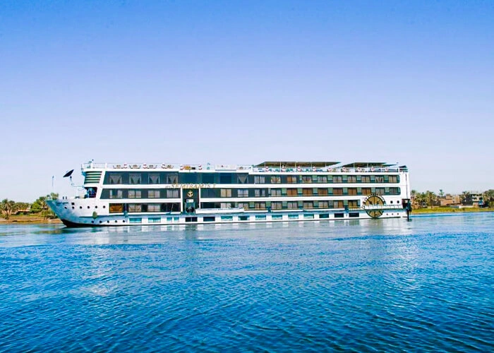 The Semramis II Nile cruise ship on the Nile, its glazed upper deck running the length of a white hull