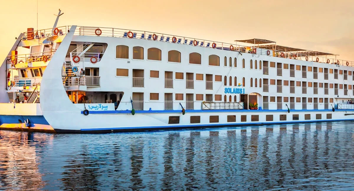 The Solaris I Nile cruise ship broadside on still water at dusk, its reflection running beneath it