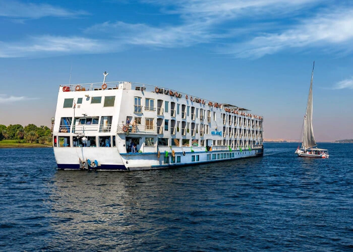 The Solaris II Nile cruise ship on the Nile with a felucca under sail beside it