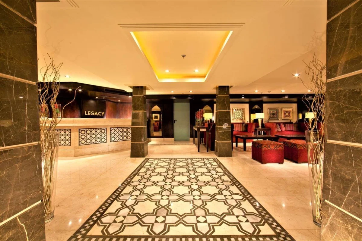 The lobby of the Steigenberger Legacy Nile cruise, a patterned stone floor between marble columns with the lounge beyond