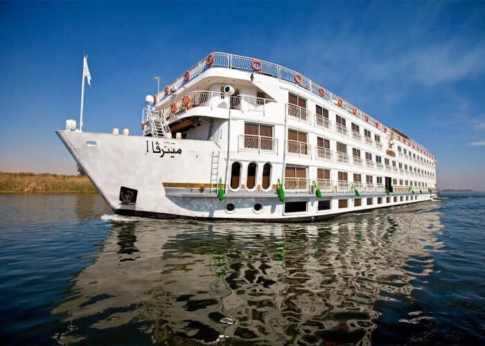 The Steigenberger Minerva Nile cruise ship on the Nile, its name in Arabic on the bow above the waterline