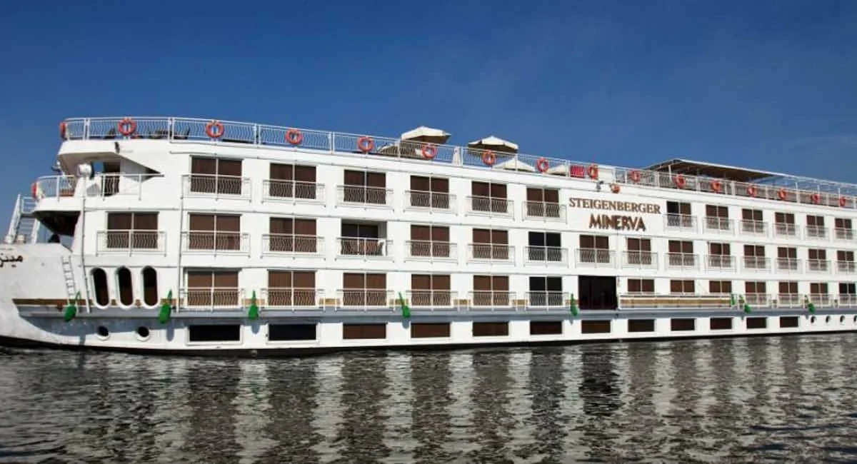 The Steigenberger Minerva Nile cruise ship under way on the Nile, seen broadside across calm water