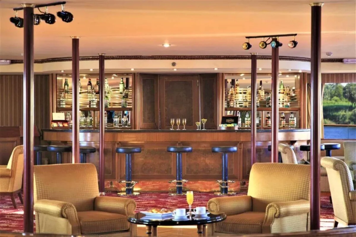 The bar on the Steigenberger Royale Nile cruise, stools at a curved timber counter with armchairs in front