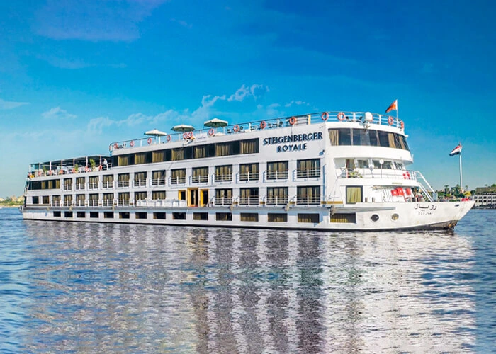 The Steigenberger Royale Nile cruise ship on the Nile, its name along the upper deck and its reflection below